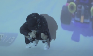 Mackned raps over cloudy beats and projections in ‘White Mountains’ video