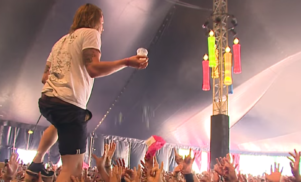 Crowd-walking singer catches beer thrown from the audience